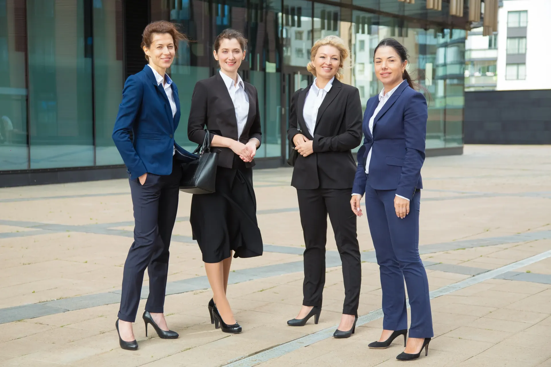 Team of four wearing tailored corporate uniforms