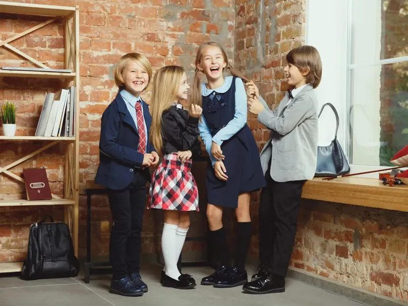 Students in school blazers, ties and skirts