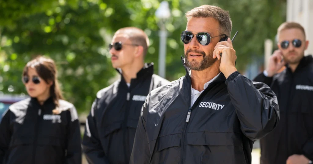 Lots of Security Guards standing in the road and wearing Security Guard Uniforms