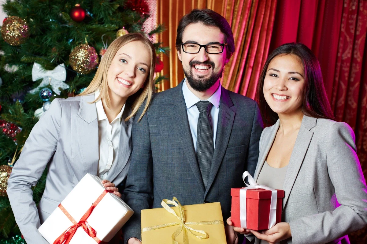 Office team exchanging presents as part of Corporate Gifting Services in UAE.