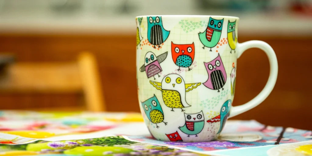 Colorful owl-printed mug showcasing creative product designs made with UV Printing Services in UAE.