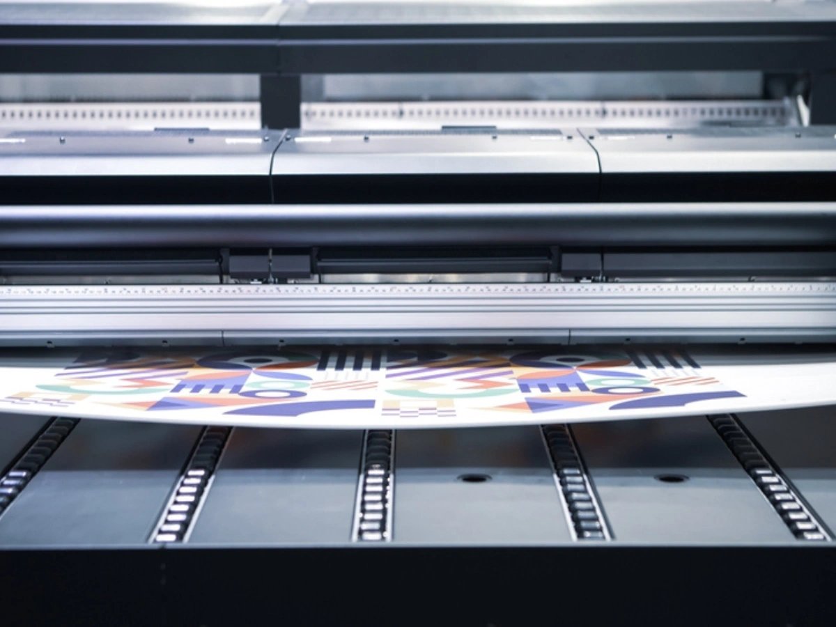 Large printer producing vibrant poster for Custom Billboard Printing.