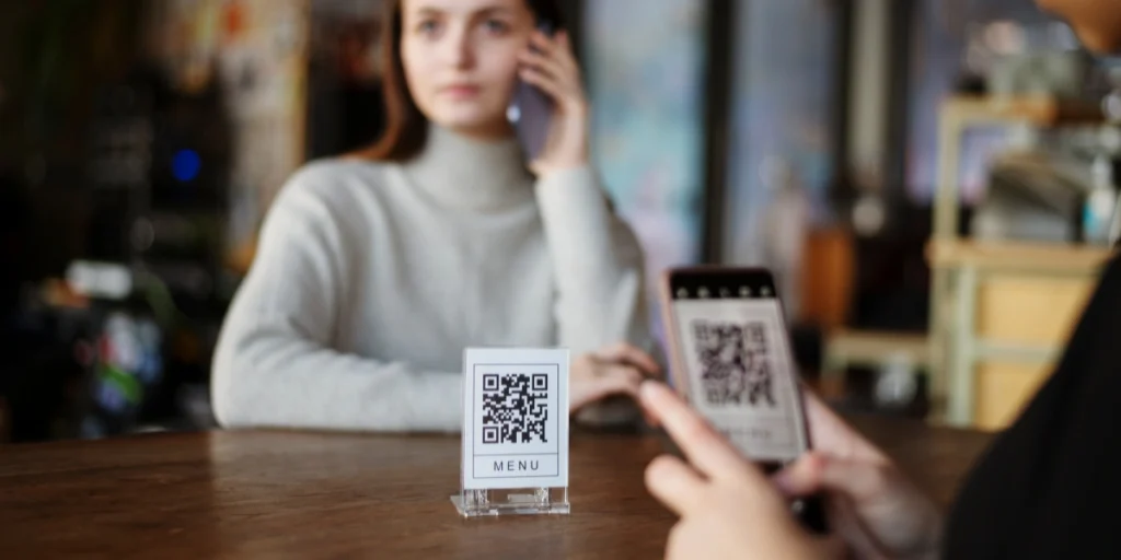 QR code printing Dubai for travel agencies, showing a desk QR stand used for brochures, bookings, and customer information.
