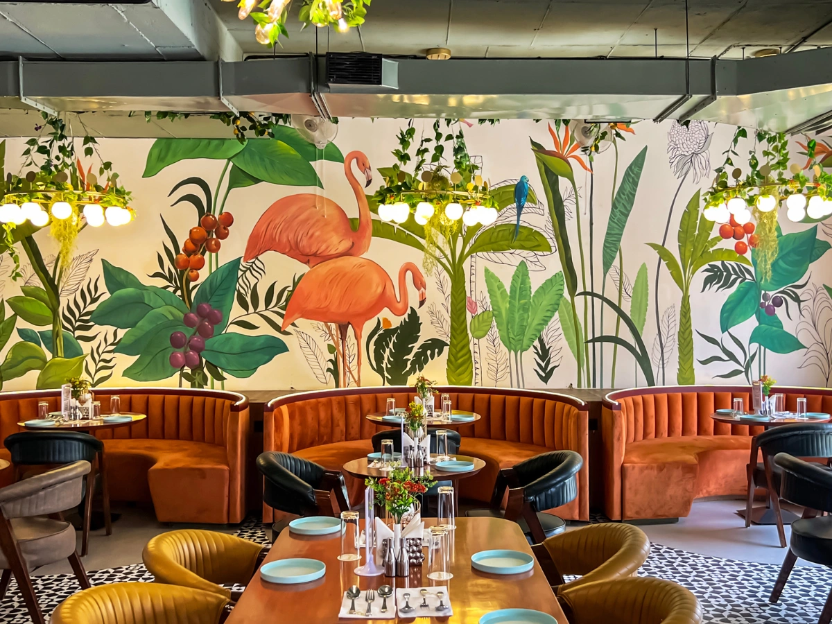 Signage printing Dubai for restaurants, featuring stylish dining interiors with table QR displays for digital menus.