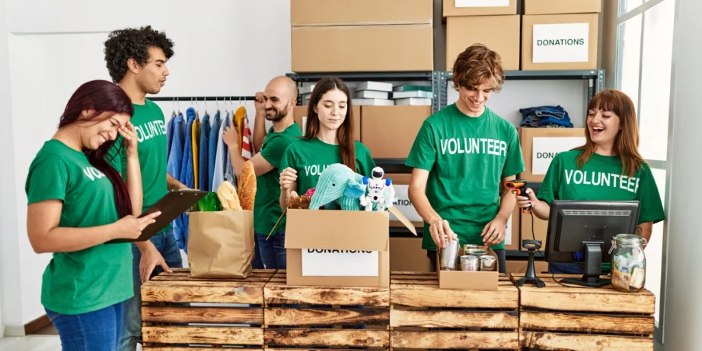 Volunteers sorting donation items in charity center, highlighting UV Printing vs DTF Dubai for branded campaigns