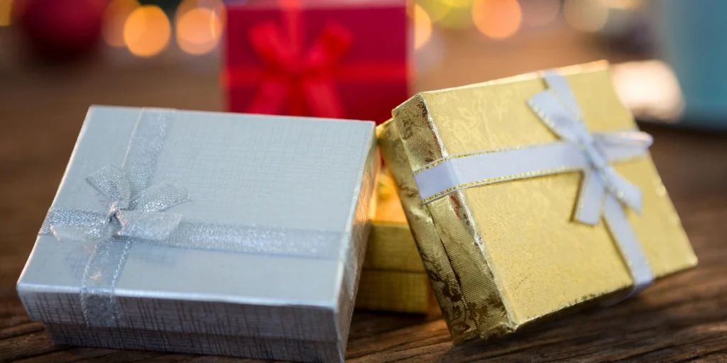 Custom Rigid Boxes Dubai luxury gift boxes with elegant ribbon packaging on wooden surface